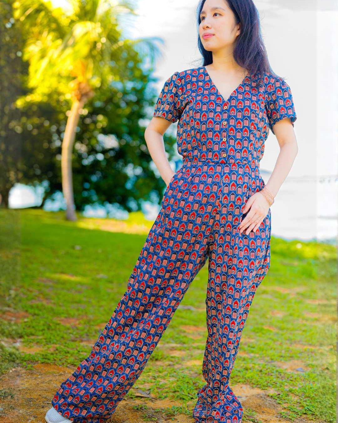 Women’s jumpsuit in royal blue and maroon cotton with short sleeves and relaxed fit, sustainable fabric.