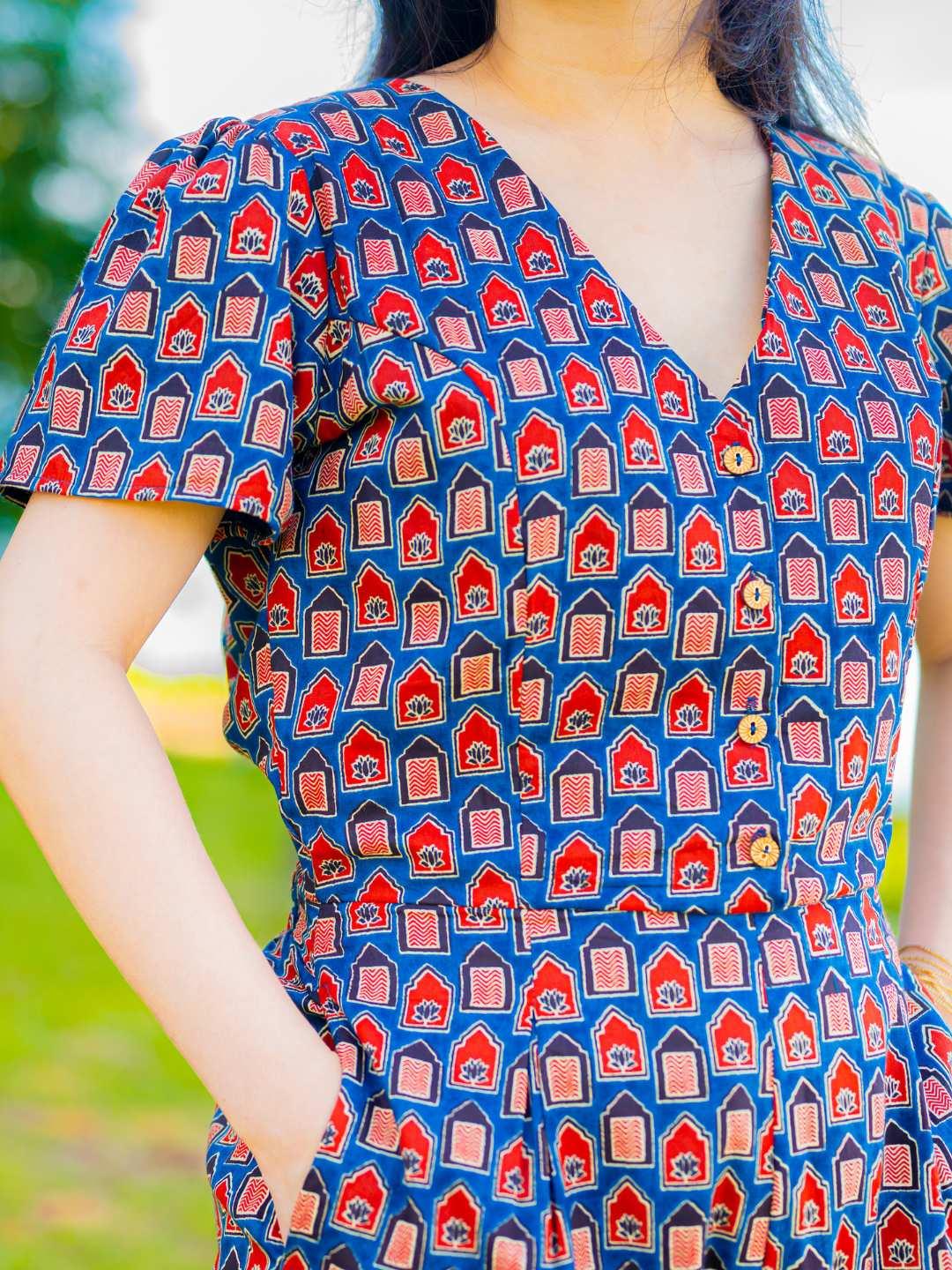 Royal blue and maroon sustainable cotton jumpsuit with short sleeves and V-neck, featuring a fitted waist and casual style.