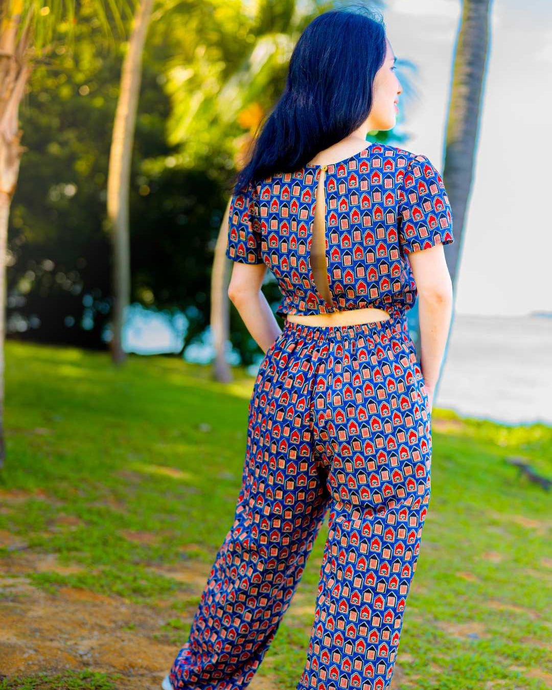 Women's royal blue and maroon cotton jumpsuit with short sleeves, zipper back, and geometric pattern, sustainable fabric.