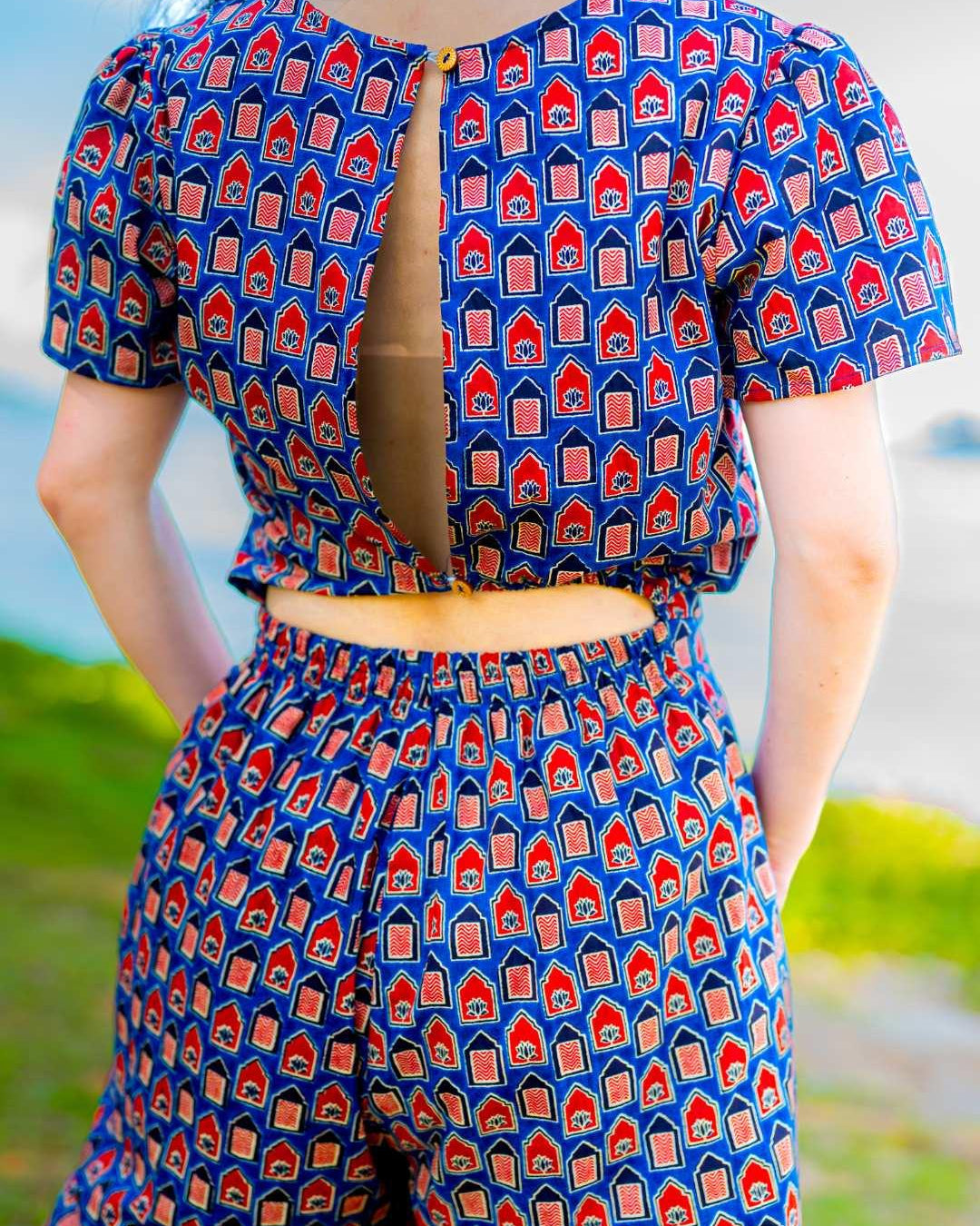 Women’s royal blue and maroon cotton jumpsuit with short sleeves and keyhole back, sustainable design.