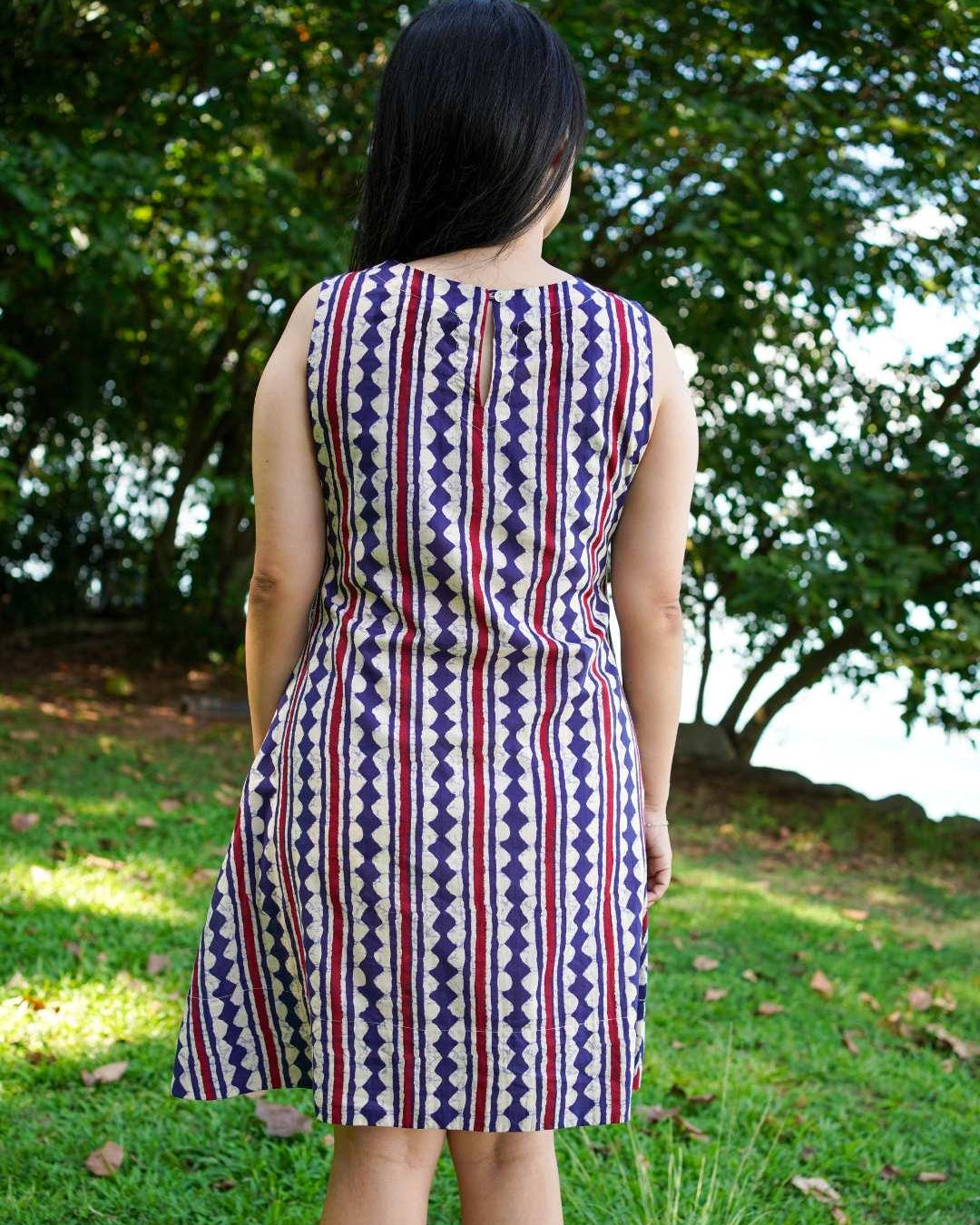 Azure and white striped A-line dress in sustainable cotton, sleeveless with a fitted waist, designed for women.