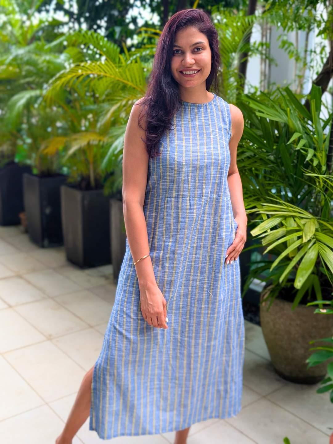 Sleeveless blue and yellow striped cotton dress with side slit, sustainable fabric, casual women's style.