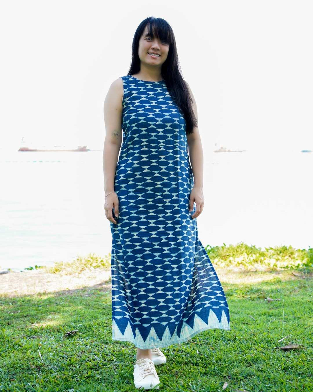 Sleeveless indigo maxi dress with side slit, geometric pattern, sustainable cotton, casual women's summer wear.