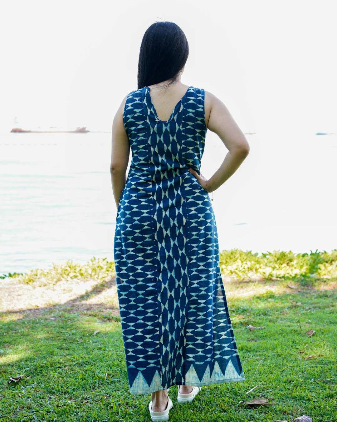 Indigo sleeveless women’s slit dress with geometric pattern and cotton fabric, sustainable casual style.