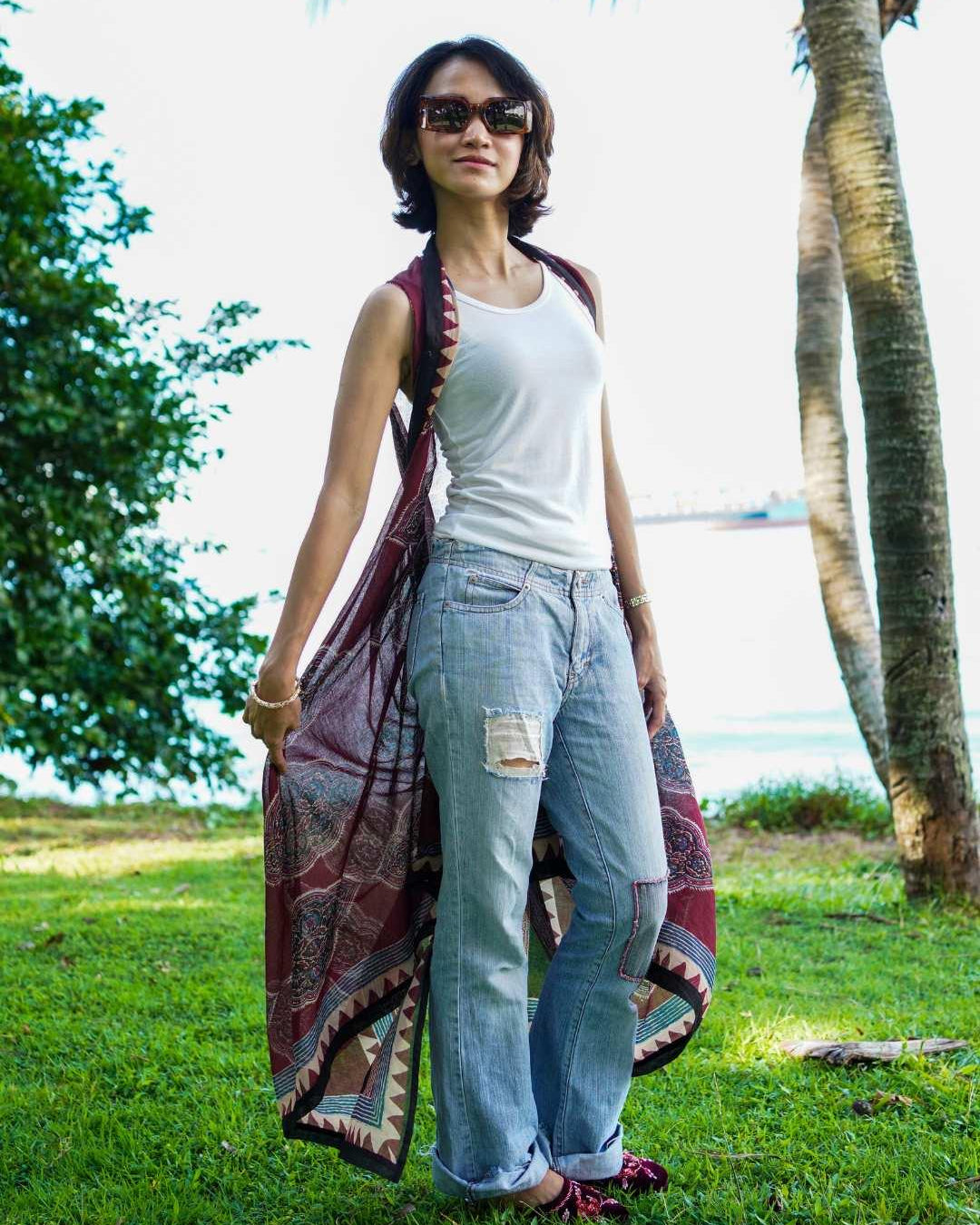 Vintage maroon sustainable cotton women's kimono with open front and printed border, styled casually over tank and jeans.