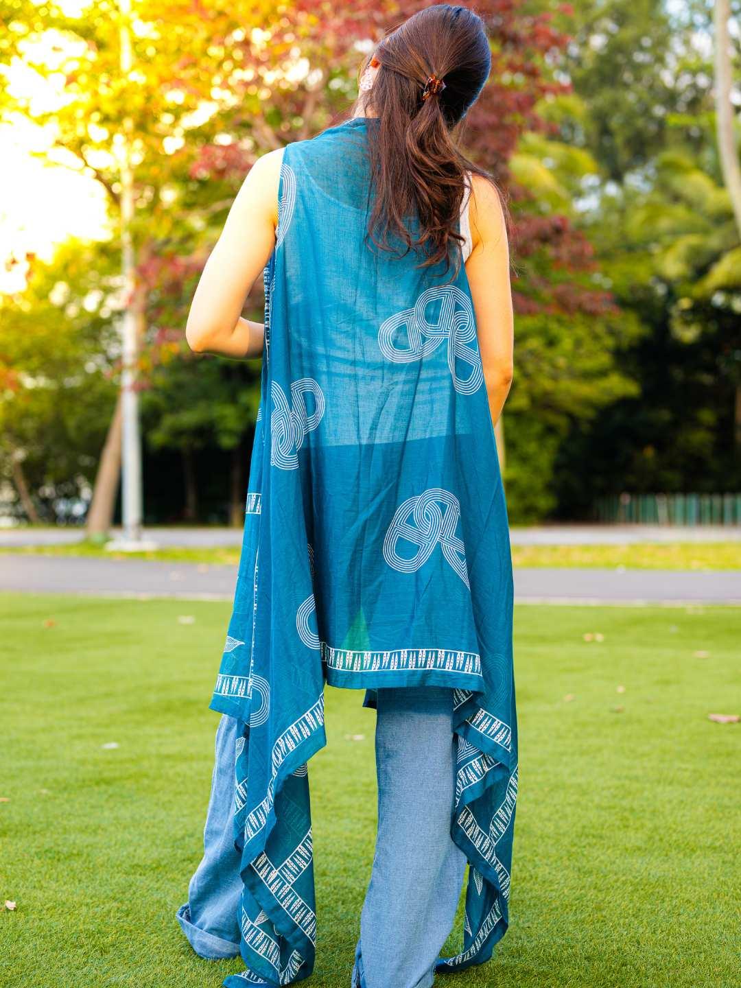 Sleeveless indigo blue women's cotton kimono with pretzel print and asymmetric hem, sustainable and casual style.