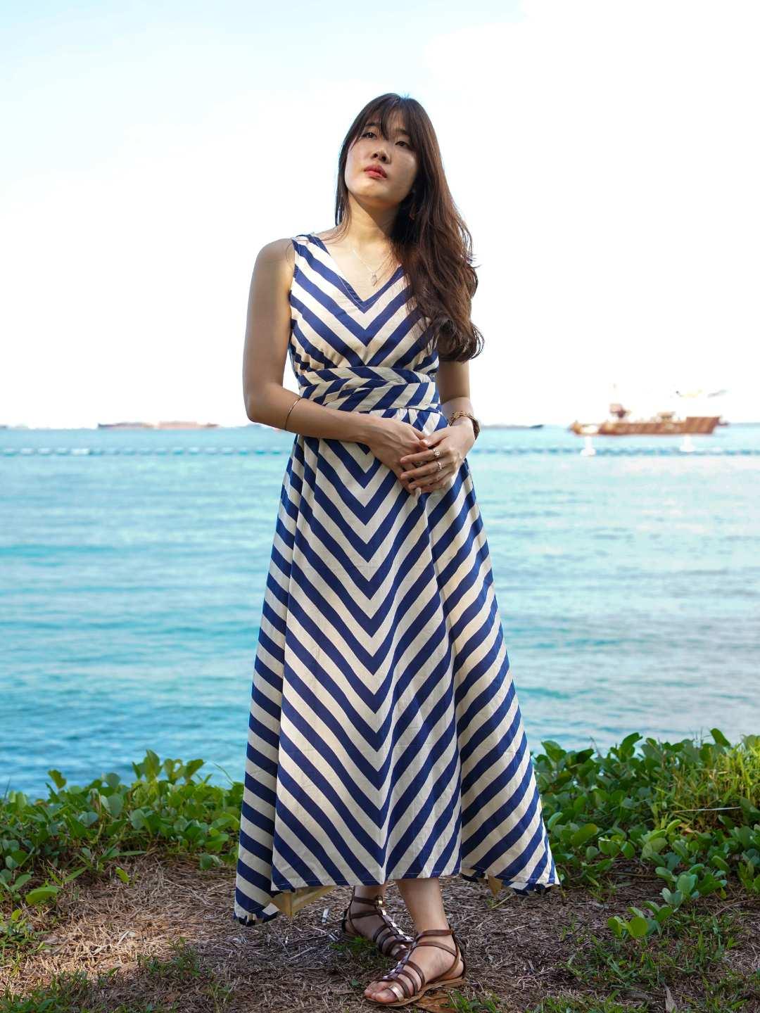 Blue and white striped cotton sleeveless women's dress with V-neck and matching obi belt, sustainable fabric.