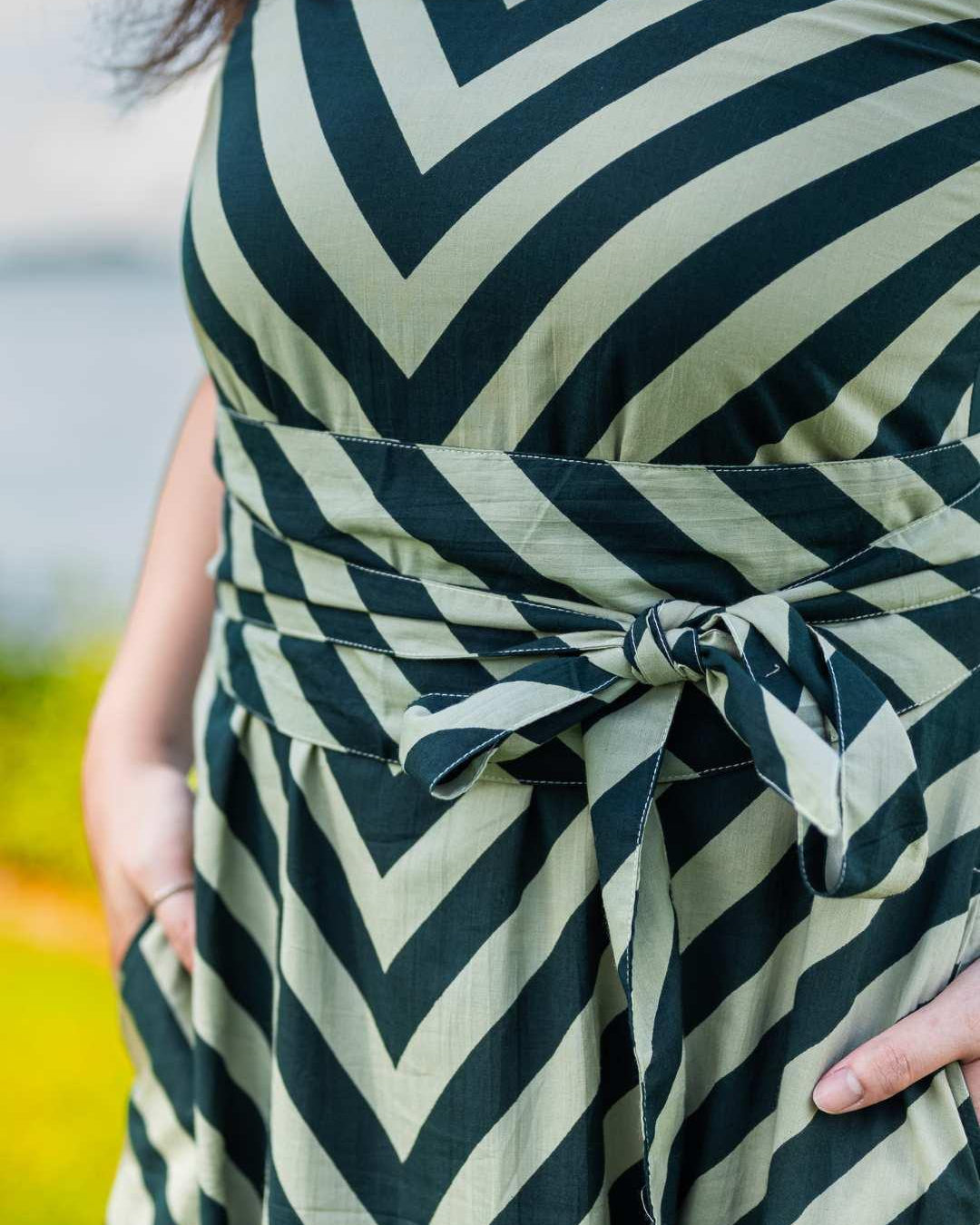 Green cotton dress with black chevron stripes and a tied obi belt, sustainable fabric, women's casual wear.