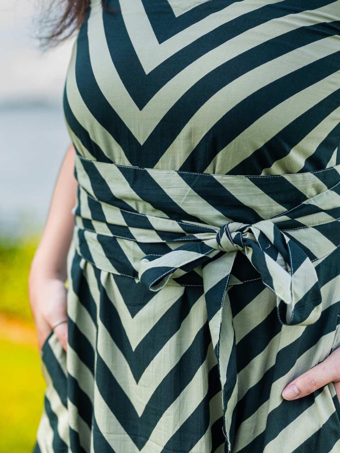 Green cotton dress with black chevron stripes and a tied obi belt, sustainable fabric, women's casual wear.
