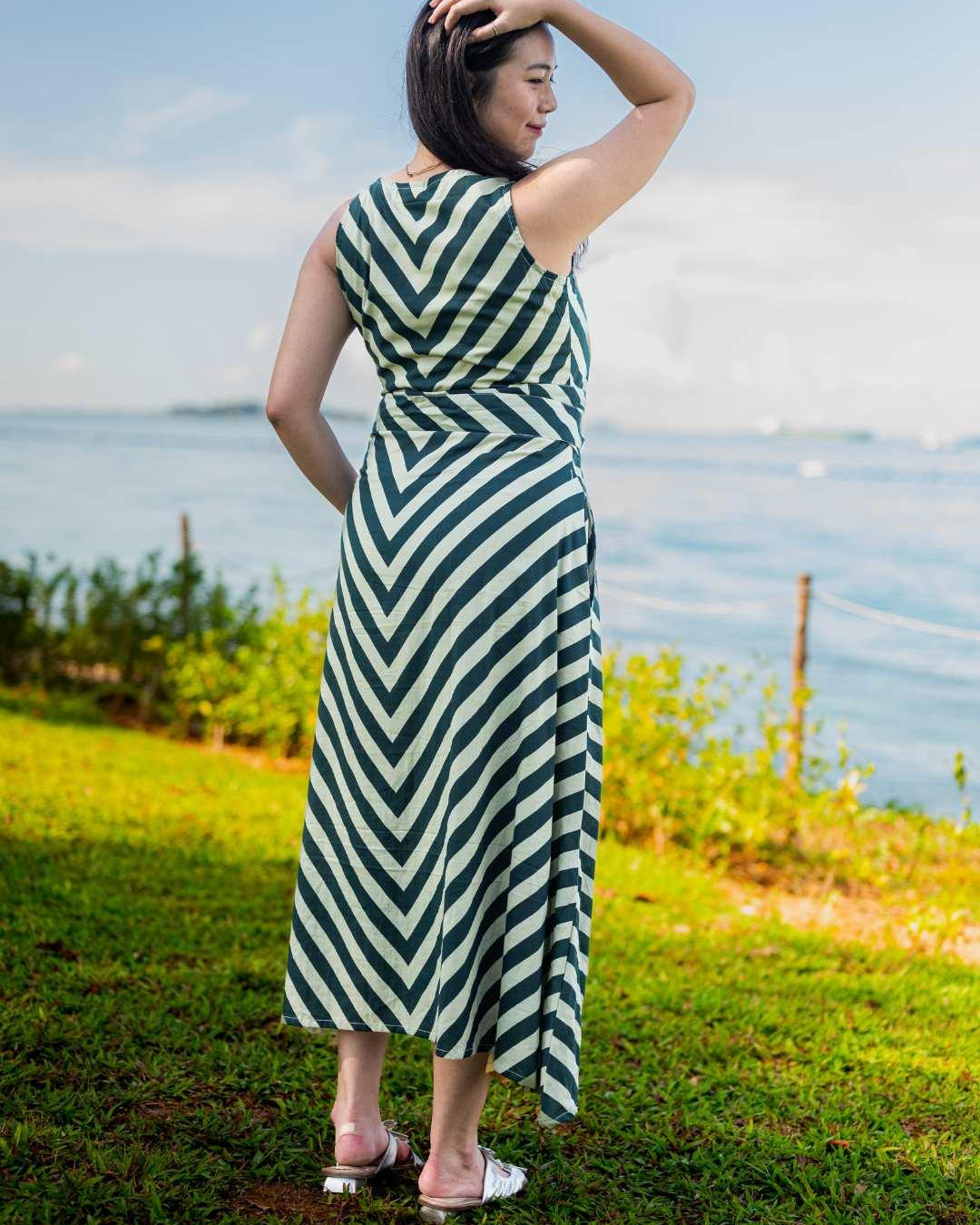 Green and white striped sustainable cotton women’s wave dress with obi belt, sleeveless and ankle-length.