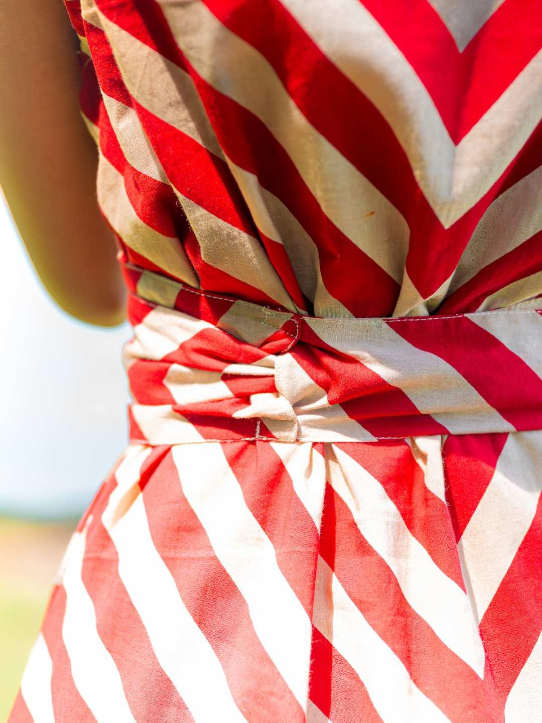 Red and white striped sustainable cotton women's dress with twisted obi belt detail at waist.