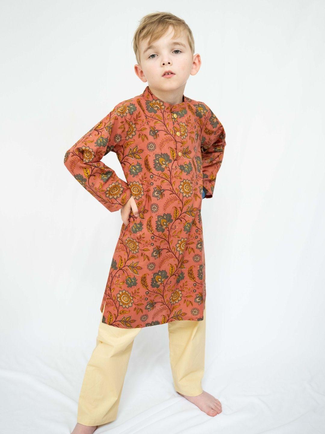 Boys’ coral kurta with intricate gold floral motifs and cream pajama pants, a vibrant Indian ethnic wear set. - Nimbu