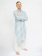 Light blue men’s ethnic kurta with subtle white patterning, paired with white pajama trousers. - Nimbu