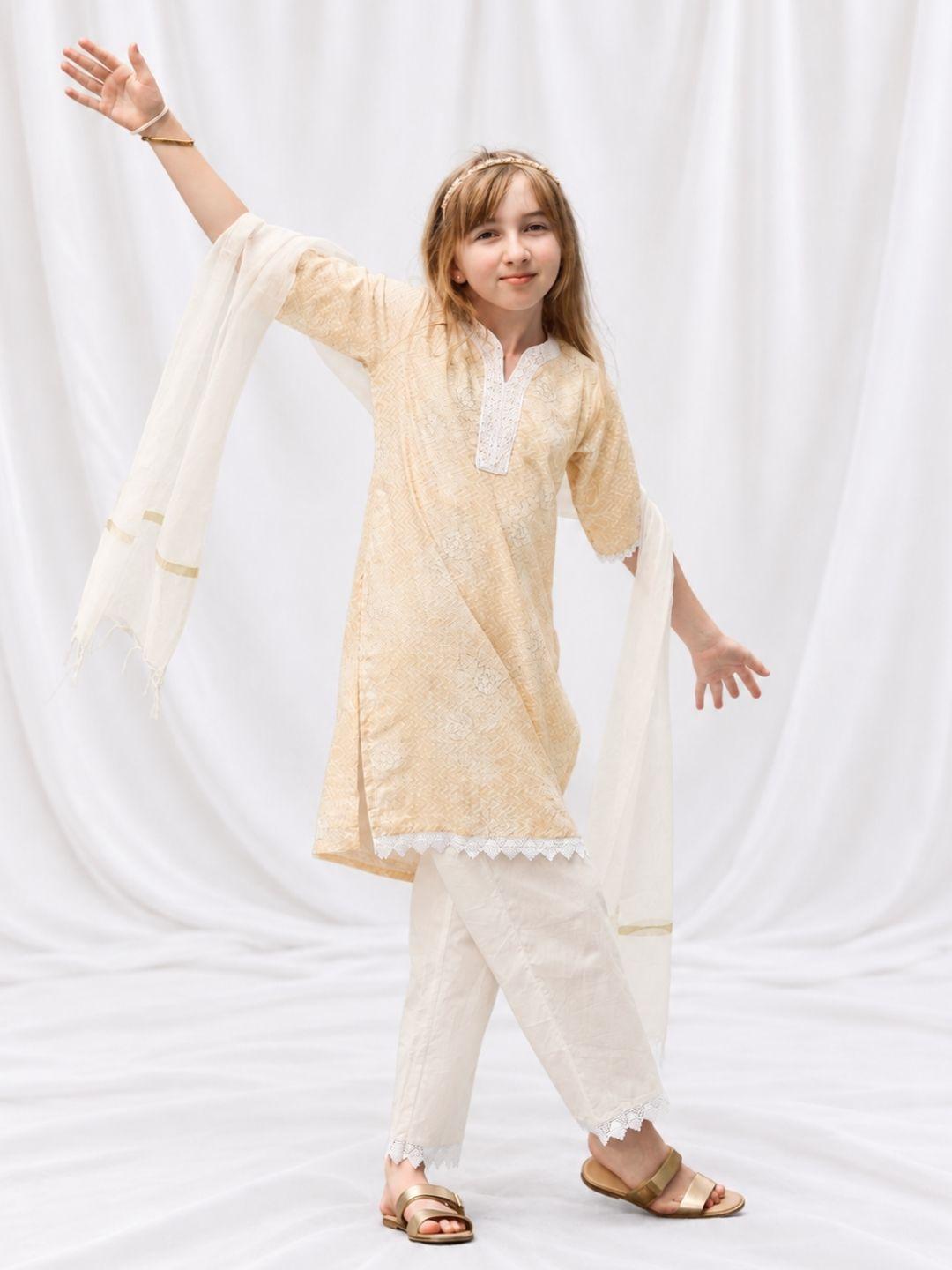 Girl wearing a pale yellow embroidered kurti and matching pants with a flowing dupatta, finished with delicate lace trim. - Nimbu
