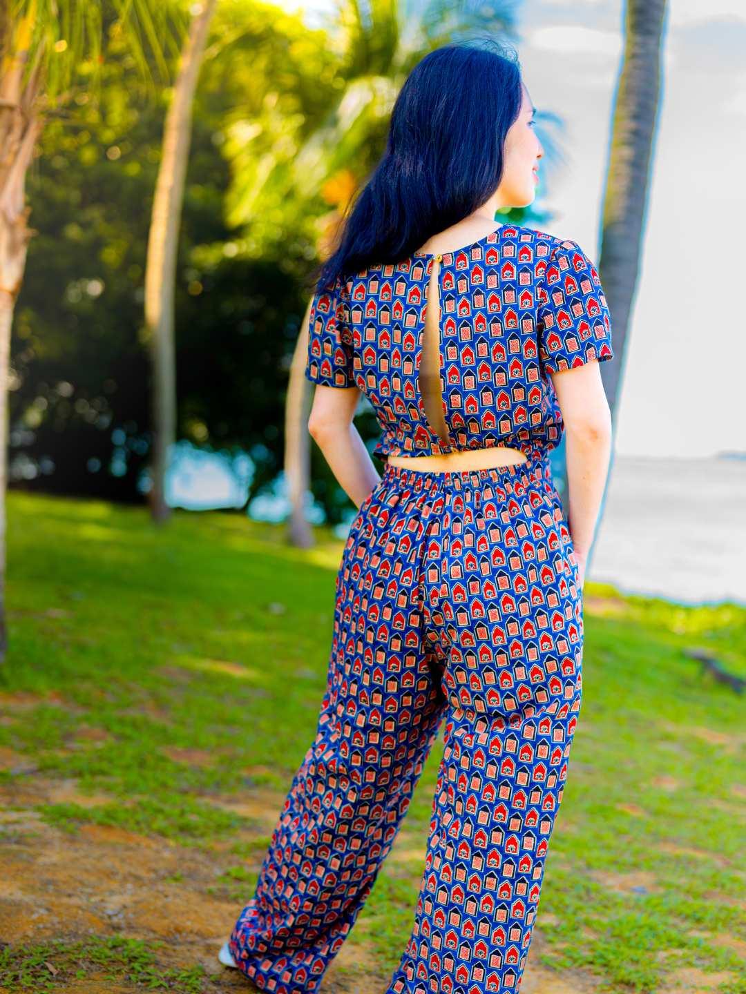 Women's royal blue and maroon cotton jumpsuit with short sleeves, zipper back, and geometric pattern, sustainable fabric.