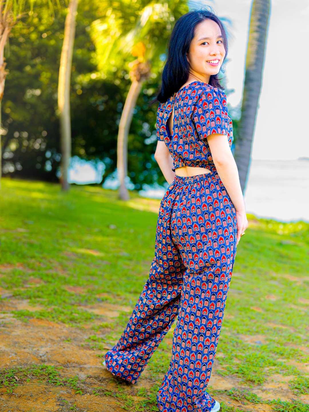 Women's sustainable cotton jumpsuit in royal blue and maroon with short sleeves and a fitted waist.