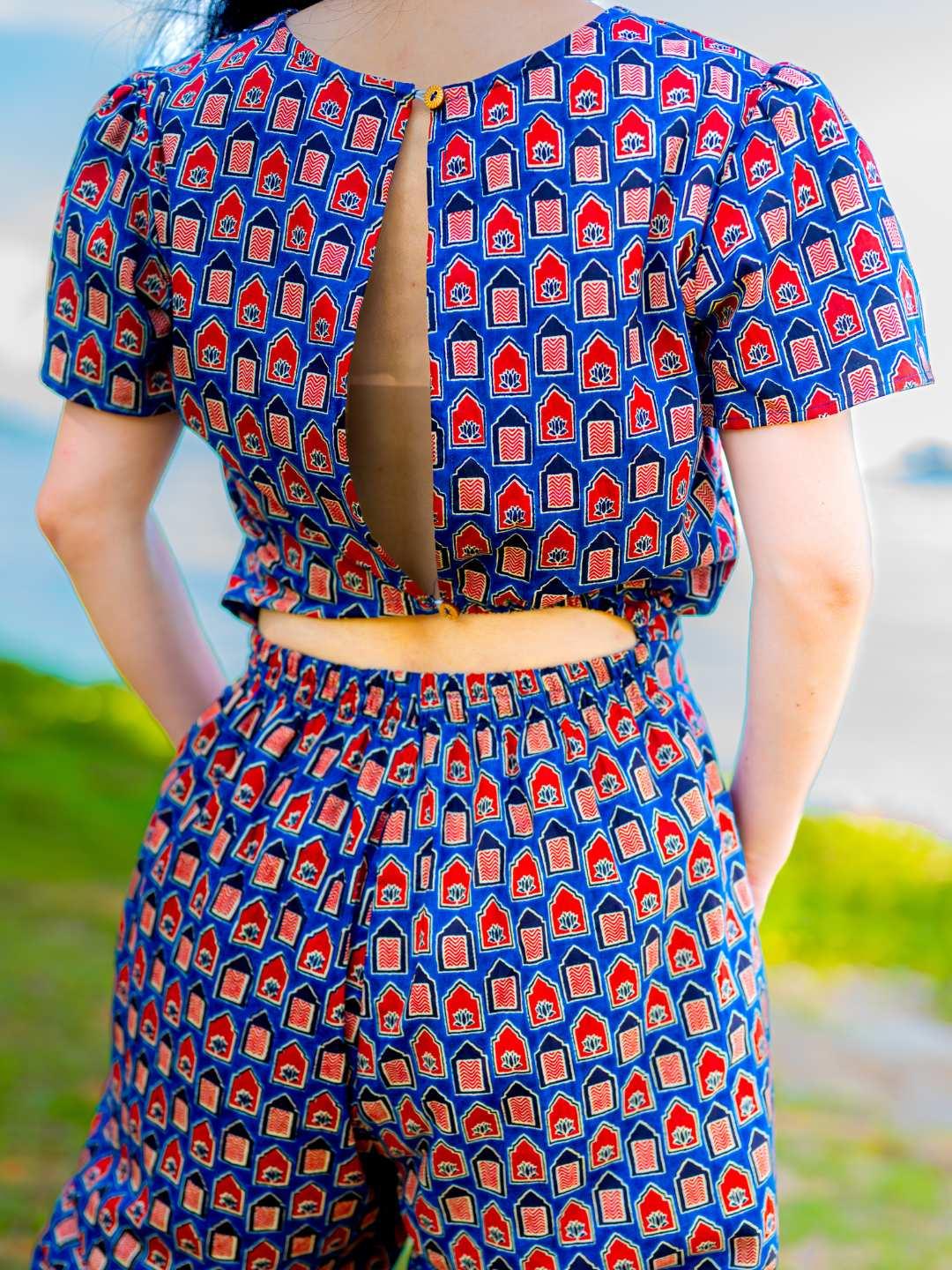 Women’s royal blue and maroon cotton jumpsuit with short sleeves and keyhole back, sustainable design.