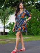 Short dress with blue and orange mosaic print, sustainable cotton, short sleeves, belted waist, casual women's style.