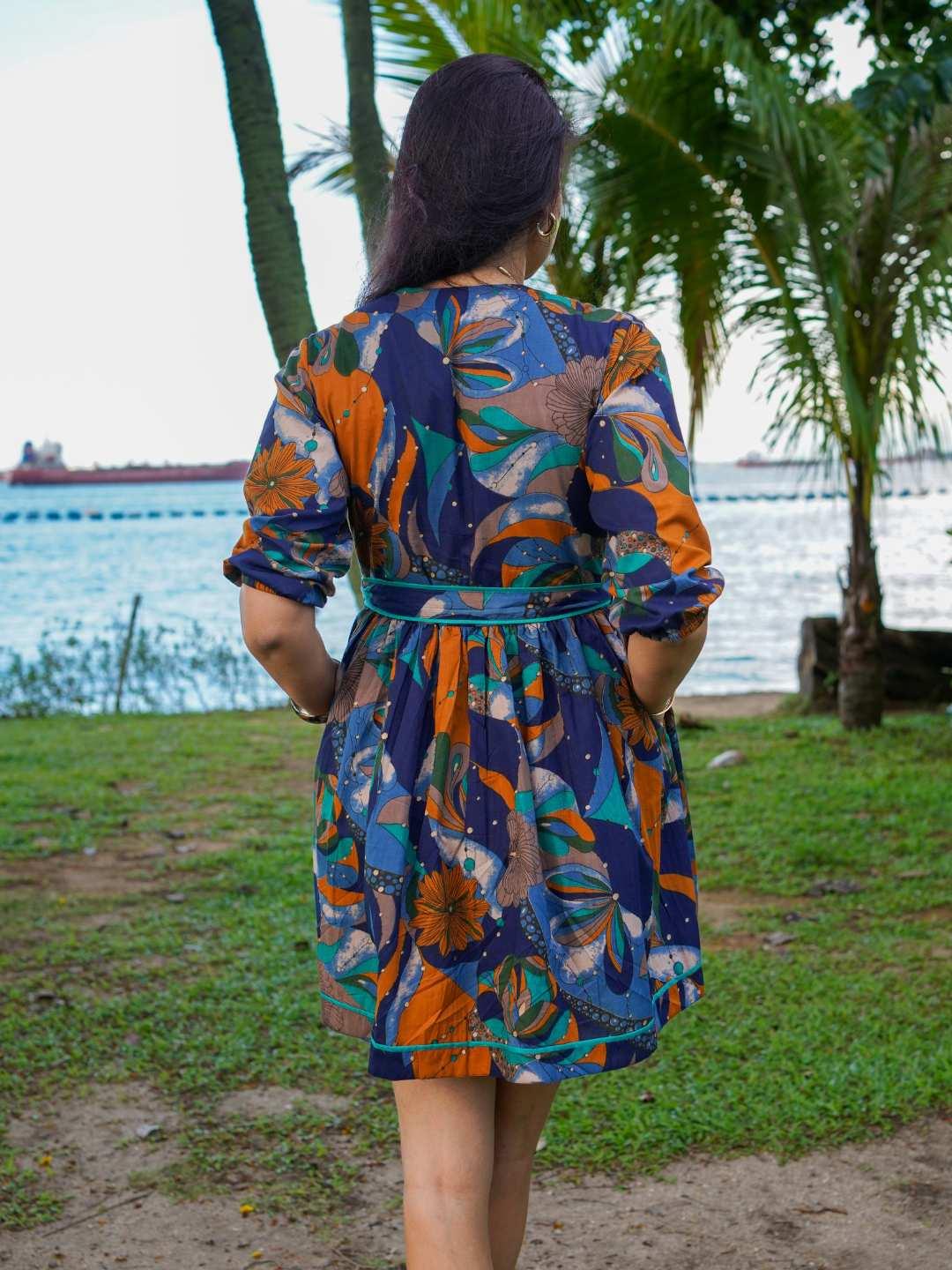 Women's Havana Ocean Mosaic short dress in blue and orange cotton with tropical print and belted waist, sustainable fabric.