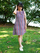 Women's sleeveless A-line dress with vertical desert stripe pattern in azure and white, made from sustainable cotton.