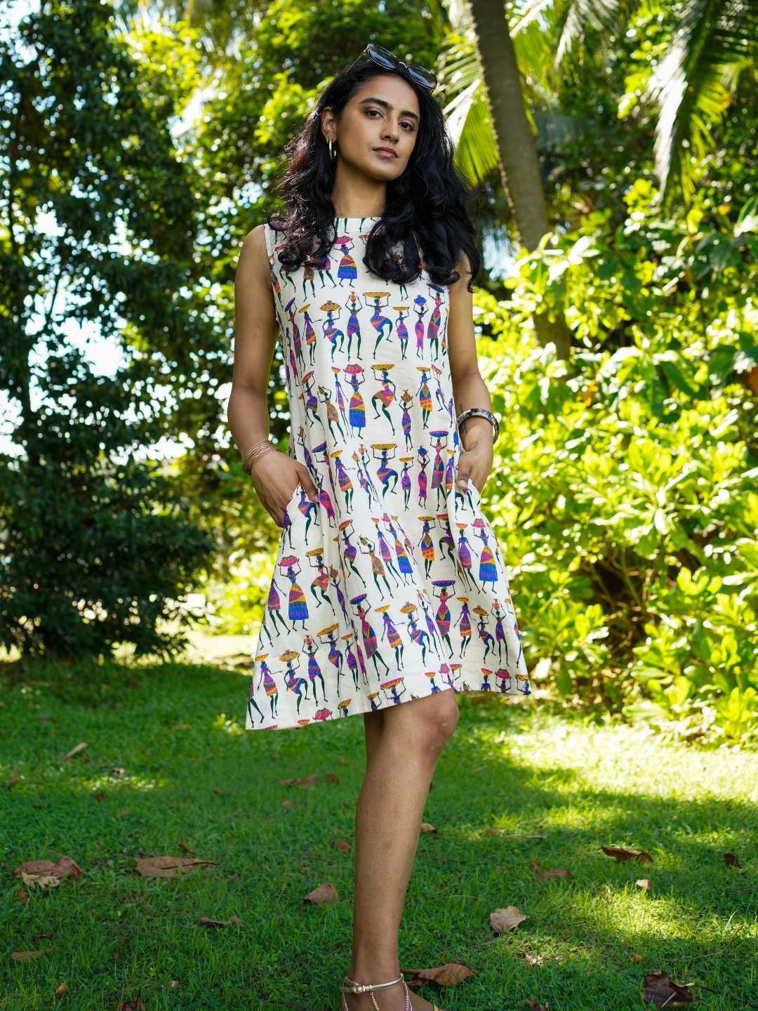 Sleeveless A-line women's dress in cotton with colorful folk story print, sustainable and casual style.