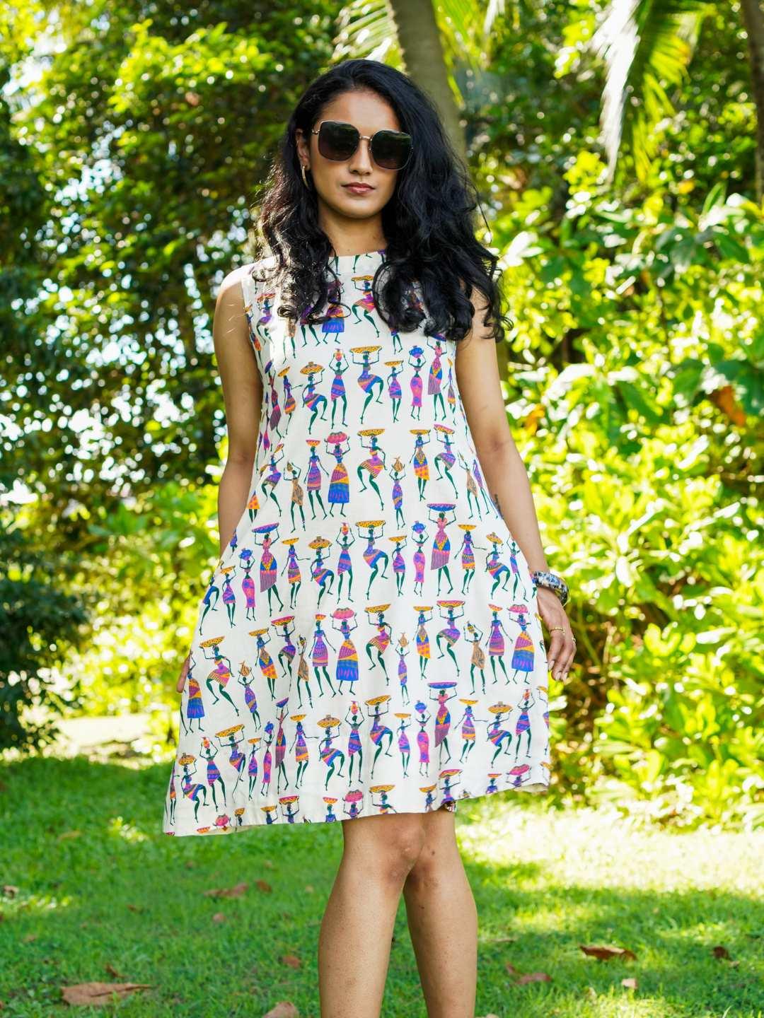 Azure sustainable cotton women’s A-line dress with colorful folk story print and cap sleeves.