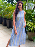 Sleeveless blue and yellow striped cotton dress with side slit, sustainable fabric, casual women's style.
