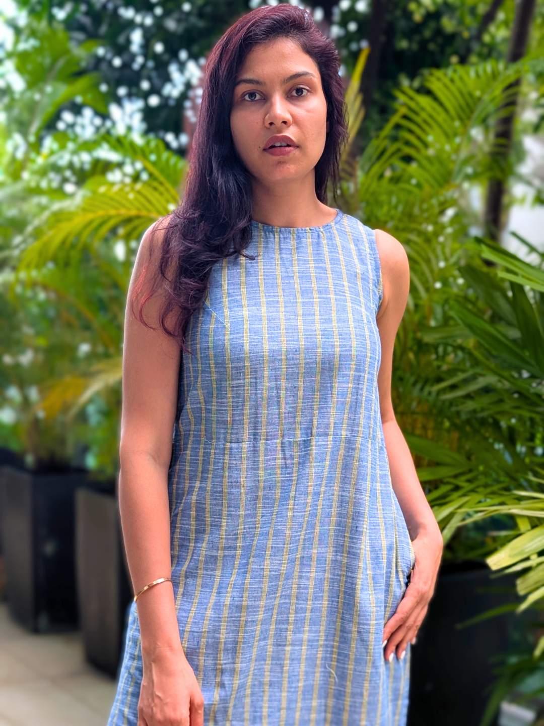 Sleeveless women's dress with blue and yellow stripes made of sustainable cotton, featuring a side slit and casual fit.