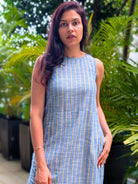 Sleeveless women's dress with blue and yellow stripes made of sustainable cotton, featuring a side slit and casual fit.