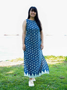 Sleeveless indigo maxi dress with side slit, geometric pattern, sustainable cotton, casual women's summer wear.