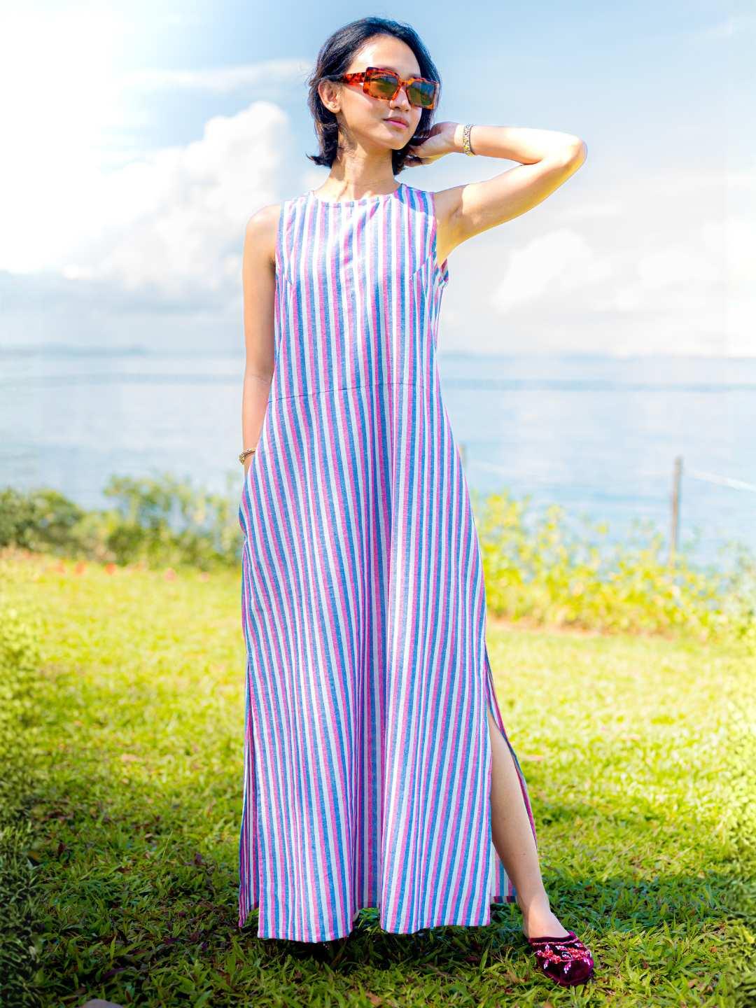 Sleeveless women's slit dress in blue and pink cotton stripes, sustainable fabric, casual summer style.