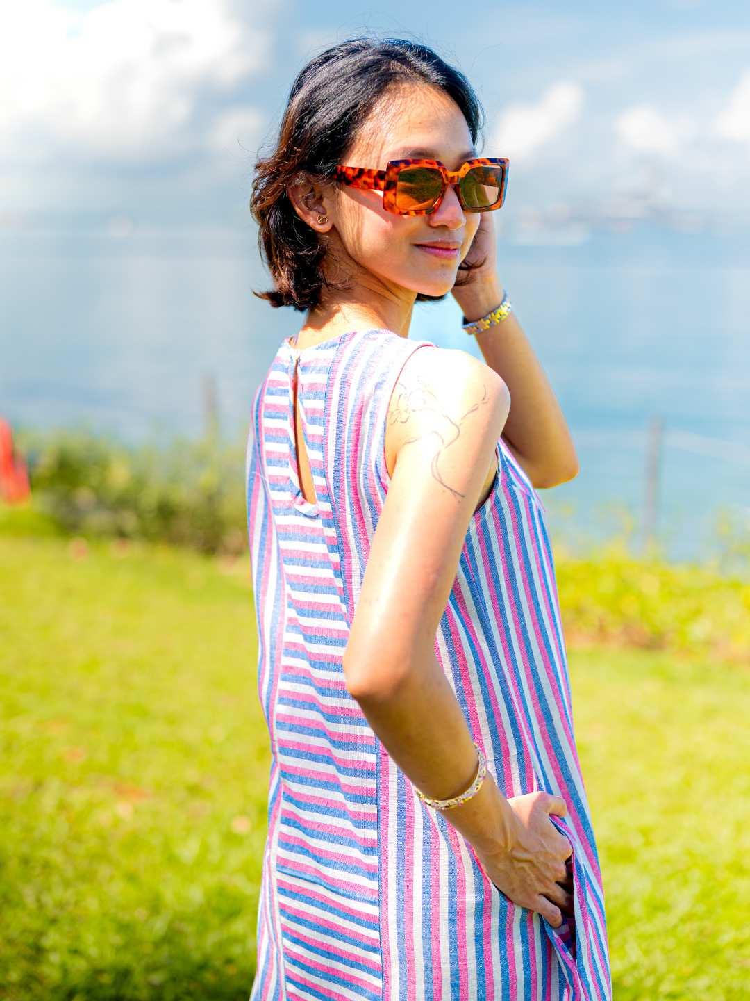Blue and pink striped sustainable cotton slit dress for women, sleeveless with a relaxed fit.