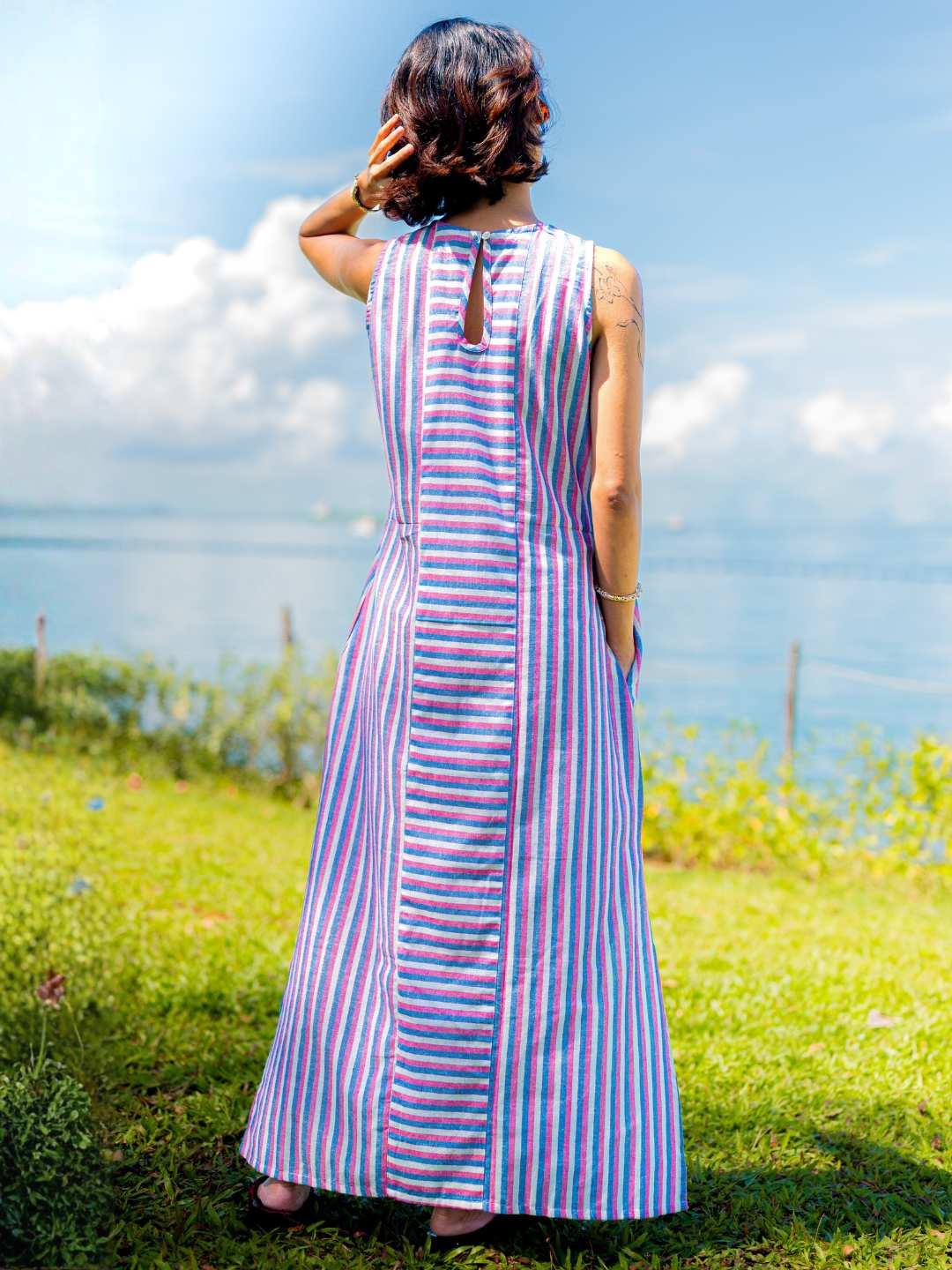 Sleeveless blue and pink striped cotton dress with back slit and tie detail, sustainable fabric for women.
