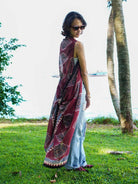 Vintage maroon sustainable cotton kimono with geometric print, sleeveless, flowing style, worn over jeans by a woman.