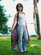 Vintage maroon sustainable cotton women's kimono with open front and printed border, styled casually over tank and jeans.