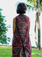 Vintage maroon cotton kimono with intricate patterns, sleeveless design, and tie-back detail in a sustainable fabric.
