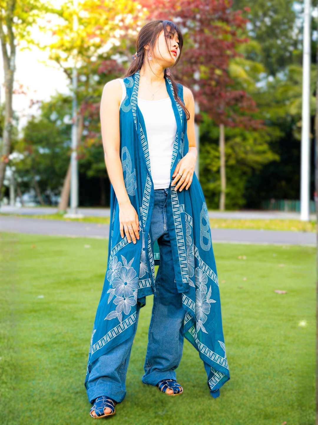 Indigo cotton kimono with pretzel pattern, sleeveless and flowy, sustainable women’s casual wear.