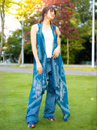 Indigo cotton kimono with pretzel pattern, sleeveless and flowy, sustainable women’s casual wear.