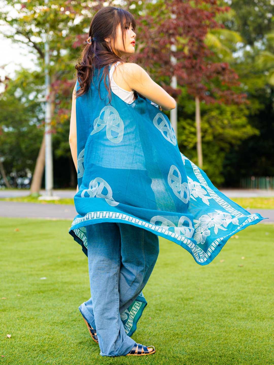 Indigo blue cotton kimono with white pretzel pattern and tassel trim, sleeveless casual wrap for women, sustainable fabric.