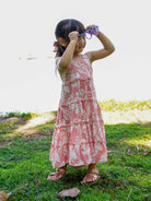 Girls long sleeveless rosy pink cotton dress with tropical leaf print, designed sustainably for casual wear.