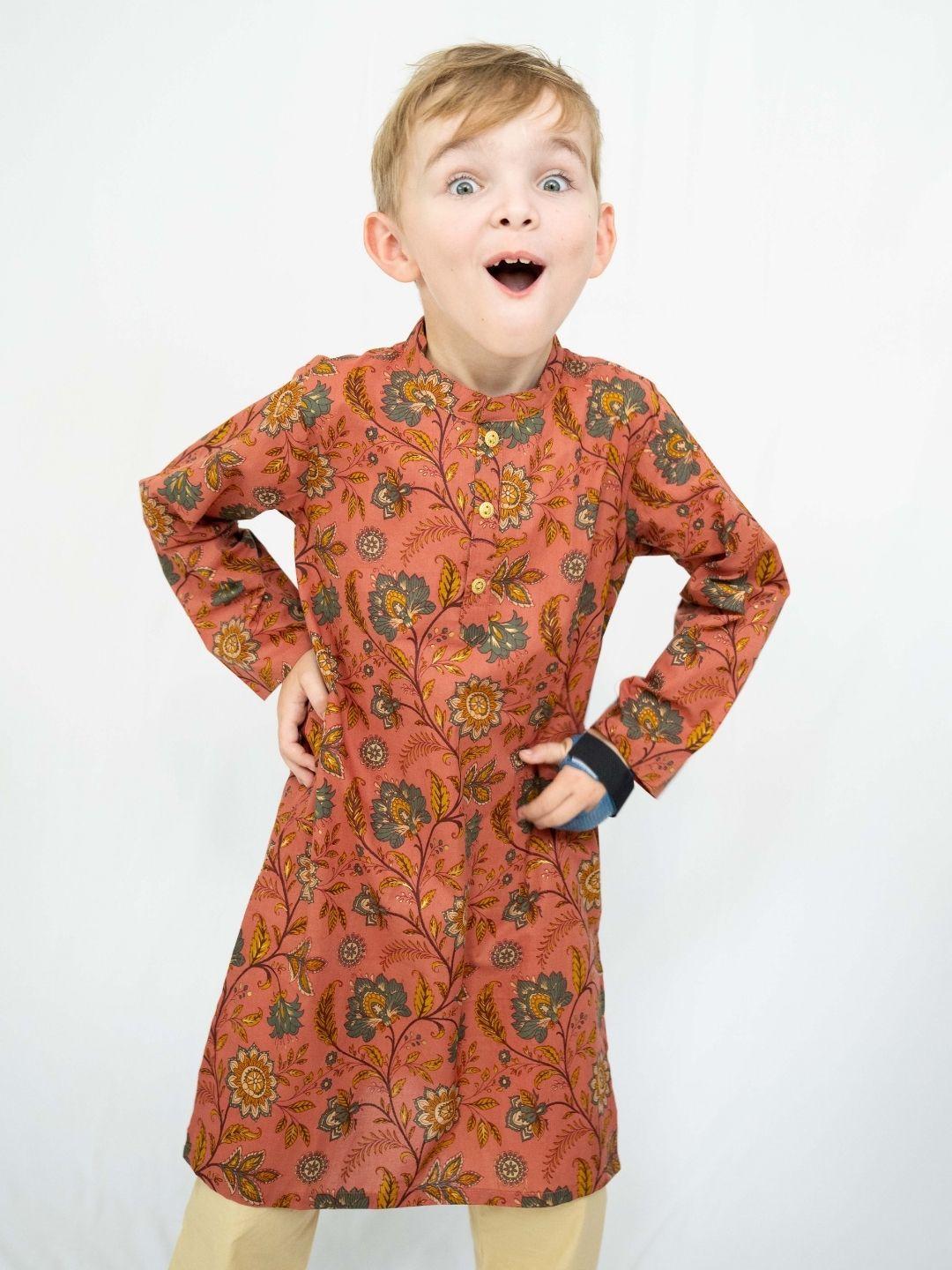 Boys’ coral cotton kurta with gold meadow floral motifs, long sleeves, and a band collar. - Nimbu