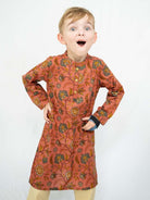 Boys’ coral cotton kurta with gold meadow floral motifs, long sleeves, and a band collar. - Nimbu