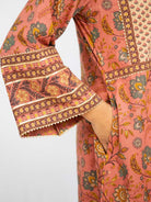 Coral cotton kurti with ornate gold floral and geometric prints, three-quarter sleeves and decorative cuffs. - Nimbu