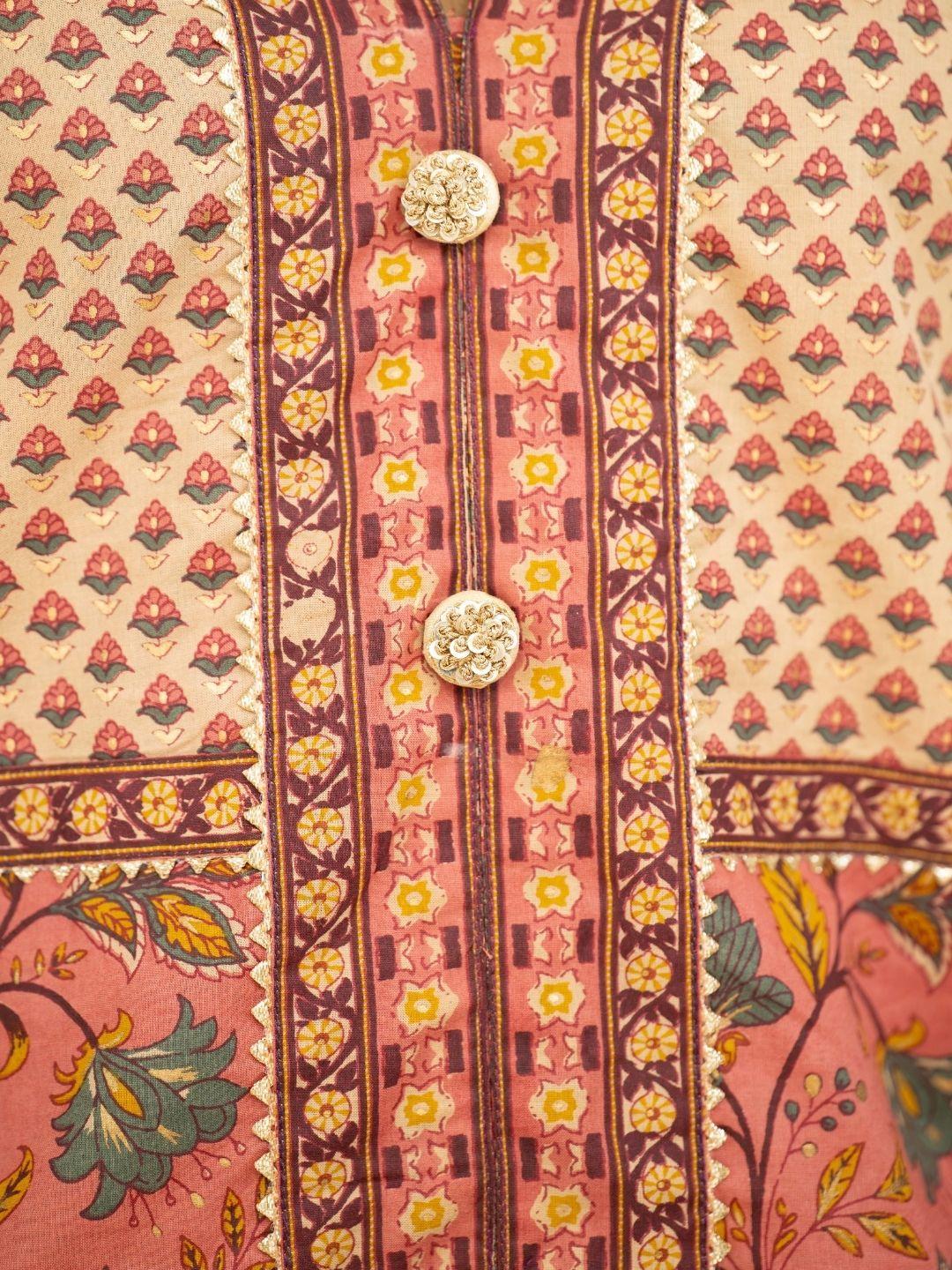 Coral and gold ethnic kurti fabric with floral motifs, patterned borders, and decorative gold buttons; pants not shown. - Nimbu
